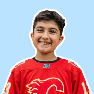 boy kid wearing hockey jersey smiling at camera